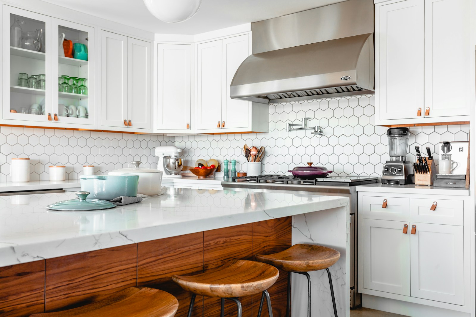 A bright kitchen with white cabinetry and natural light